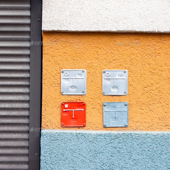 Colorful building wall with sign plates for natural gas pipes Stock